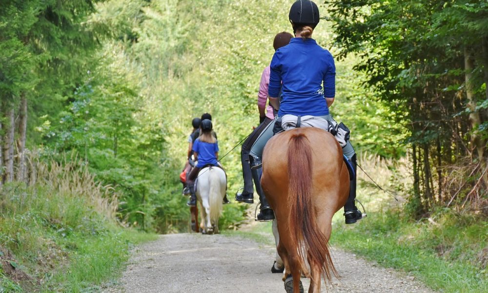 Female and Child riding Horse.